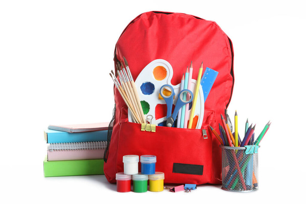 backpack and school stationery isolated on white - Foto, Bild