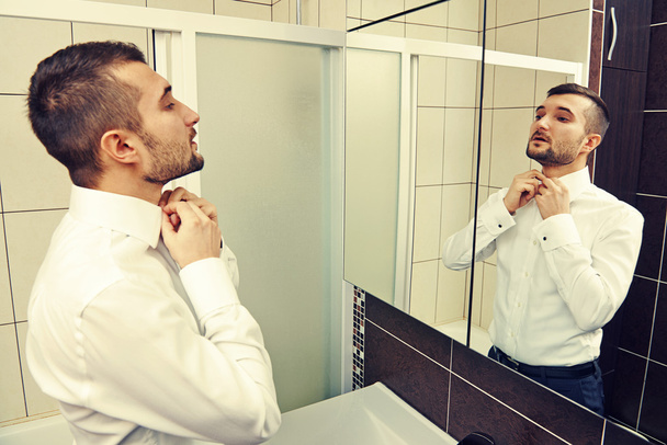 handsome man looking at mirror - Photo, Image