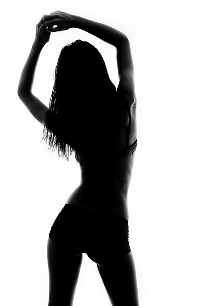 silhouette of a slender girl in lingerie - Фото, изображение