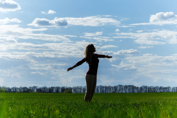 Vapaus tuntea olonsa hyväksi ja matkustaa on seikkailukäsite. Kopioi tilaa naisen siluetti nostamalla kädet sininen taivas ja valkoinen pilvi taustalla auringonvalo
. - Valokuva, kuva
