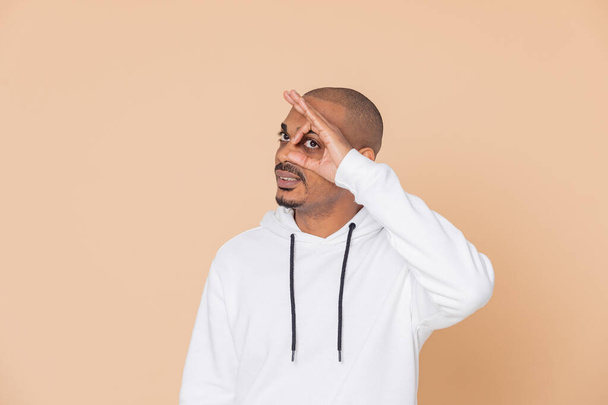 African guy with a white sweatshirt on a yellow background - Foto, Imagem