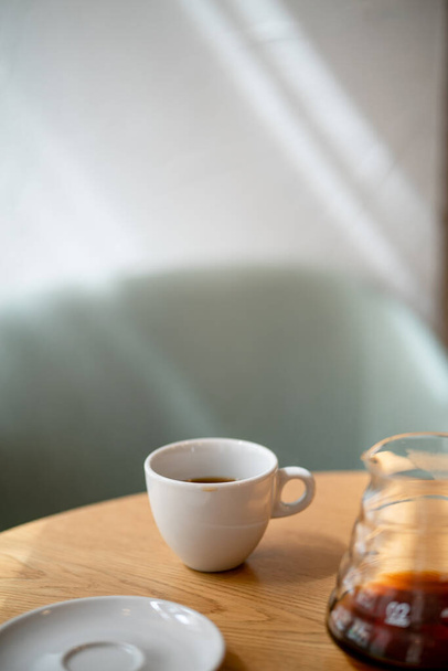 Black filter coffee on the table in cafe service kettle hario pour over cup side view - 写真・画像