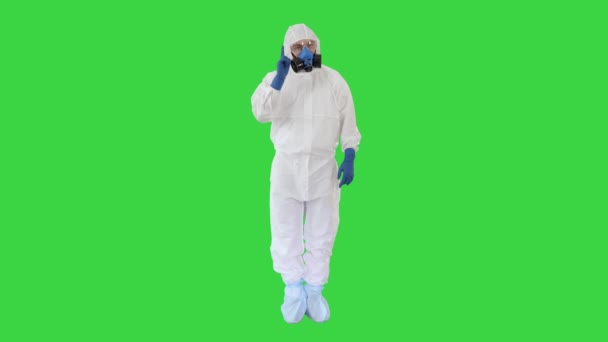 Doctor wearing hazard suit pointing with finger up wanting your attention on a Green Screen, Chroma Key. - Кадри, відео