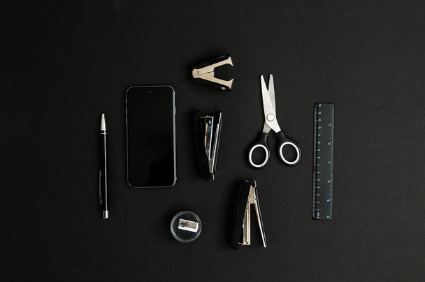 Mix of office supplies and business gadgets on a modern desk - 写真・画像