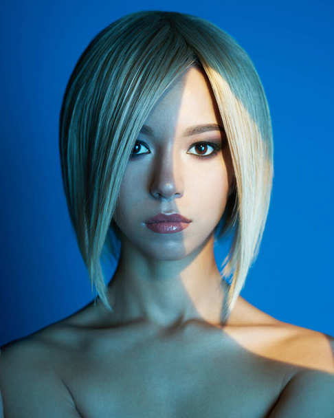 Fashion studio portrait of lovely asian woman with blonde short hair. Bright makeup. Fashionable haircut. Sexy young model in night club - Fotografie, Obrázek