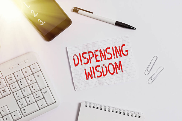 Writing note showing Dispensing Wisdom. Business photo showcasing Giving intellectual facts on variety of subjects Flat lay above computer mobile phone pencil and copy space note paper. - Photo, Image