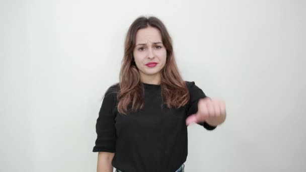 Upset Girl With A Bad Mood Puts Her Thumbs Down As Sign Of Dissent, Opposition - Materiaali, video