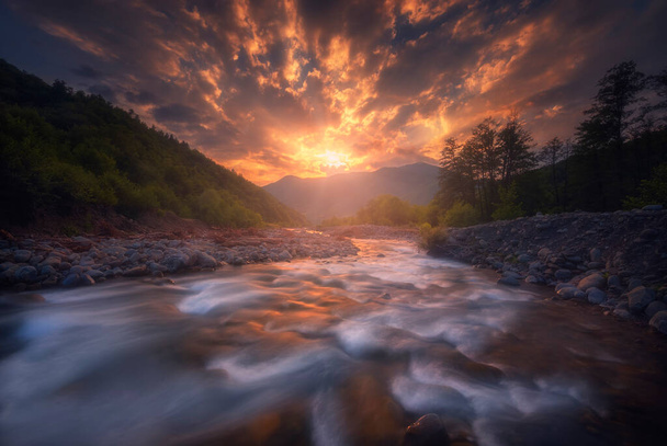 Beautiful sunset over fast flowing mountain river. Caucasus Mountains. Racha - Photo, Image