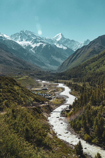 Un fleuve qui coule à travers une vallée au milieu des montagnes de l'Himalaya
 - Photo, image