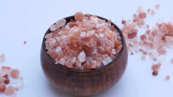 Close-up of wooden bowl with light pink Himalayan crystal salt. Top view. - Footage, Video