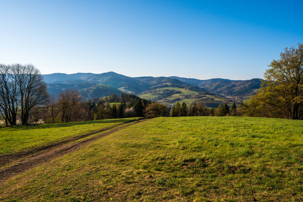 green field in the mountains with a valley below and the sun on the horizon, czech - Fotoğraf, Görsel