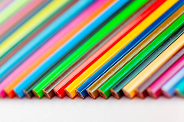 color pencils laid out in a row on a white background, close-up - 写真・画像