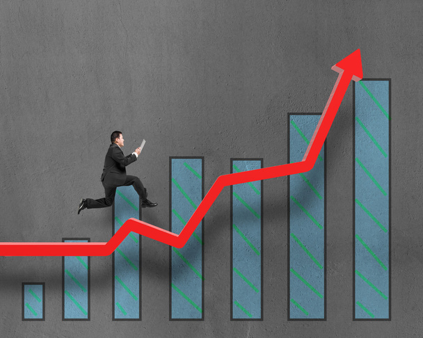 Бизнесмен, бегущий по красной стрелке роста с графиком
 - Фото, изображение