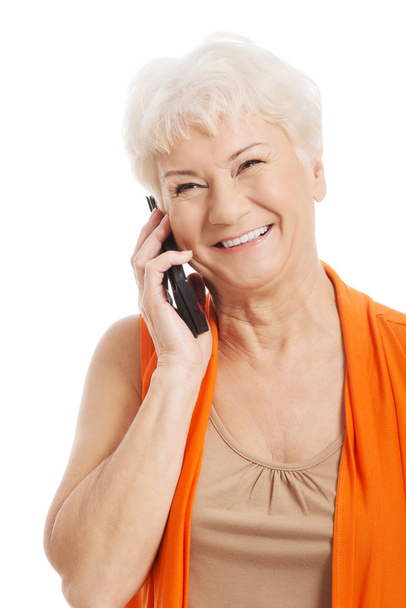 An old woman talking through phone. - Photo, Image