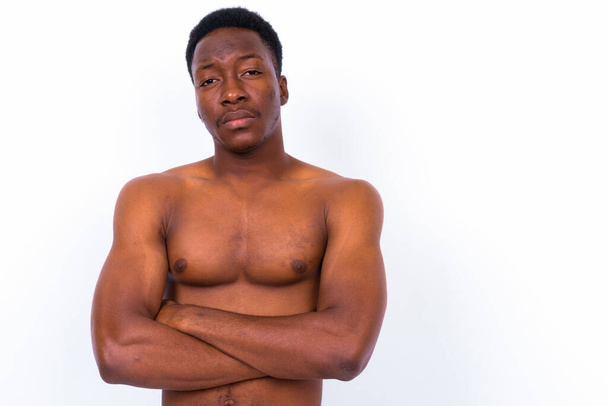 Studio shot of young handsome African man shirtless against white background - Фото, зображення
