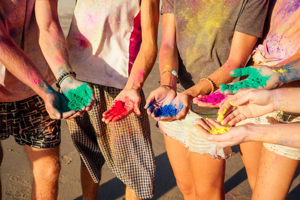 multinational multicultural mixed race friends in holi dust on beach in Goa - Foto, imagen
