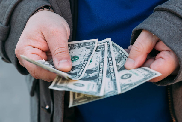 Крупный план Руки подсчитывают деньги Американские доллары, подсчитывая деньги Американские доллары рукой
 - Фото, изображение