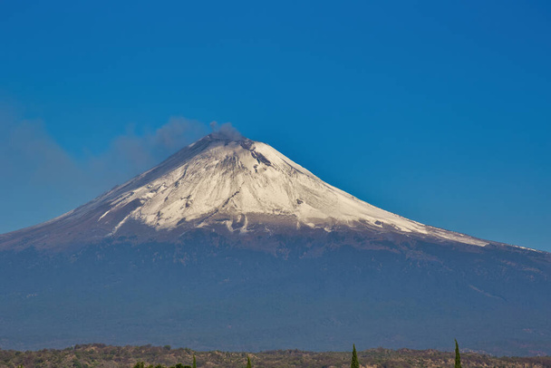 snowy popocatepetl volcano with blue sky - Photo, Image
