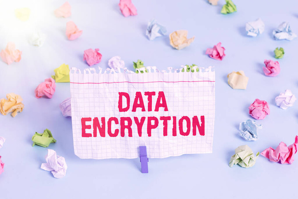 Text sign showing Data Encryption. Conceptual photo Symmetrickey algorithm for the encrypting electronic data Colored crumpled papers empty reminder blue floor background clothespin. - Photo, Image