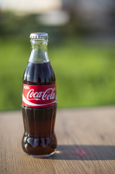 Atlanta USA May 1 2020 classic glass Coca Cola Bottle on wooden table outdoors - Photo, Image