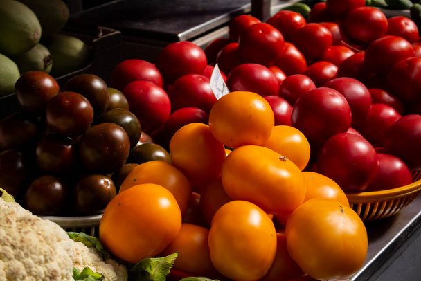 variety of yellow, red and reddish tomatoes in trays selective focus - Photo, Image