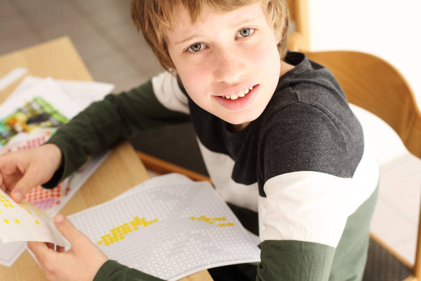 Cute 12 years old autistic boy drawing - Photo, Image