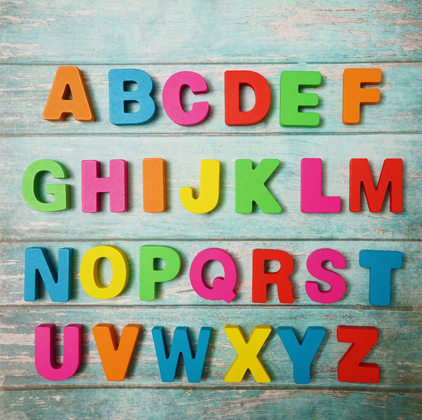 Wooden letters of English alphabet on  board  background, top view - Zdjęcie, obraz