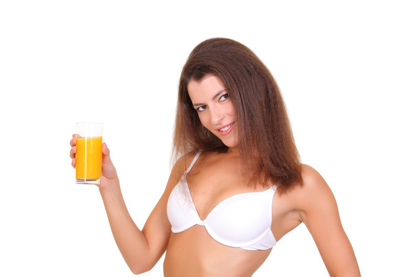 Beautiful athletic girl with a glass of orange juice - Photo, Image