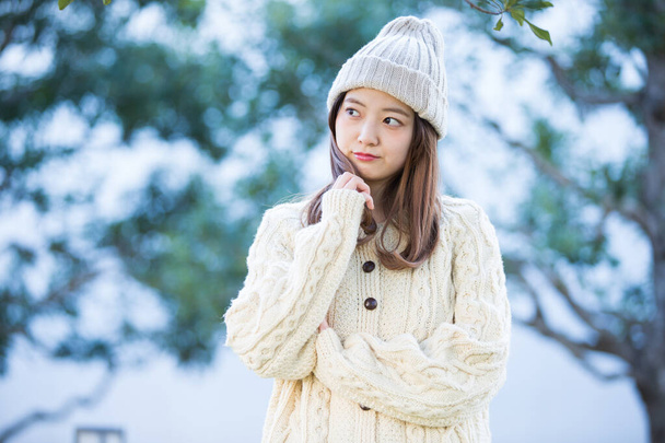 Asian (Japanese) young woman with a worried and anxious expression outdoors - Photo, Image