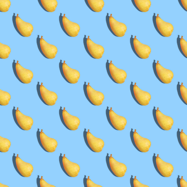Seamless pattern of ripe pears on a blue background. Close up. - Fotografie, Obrázek