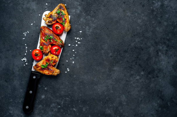 Κινέζικο μαχαίρι μπαλτά με τηγανητά φτερά κοτόπουλου κρέας και κόκκινες ντομάτες - Φωτογραφία, εικόνα