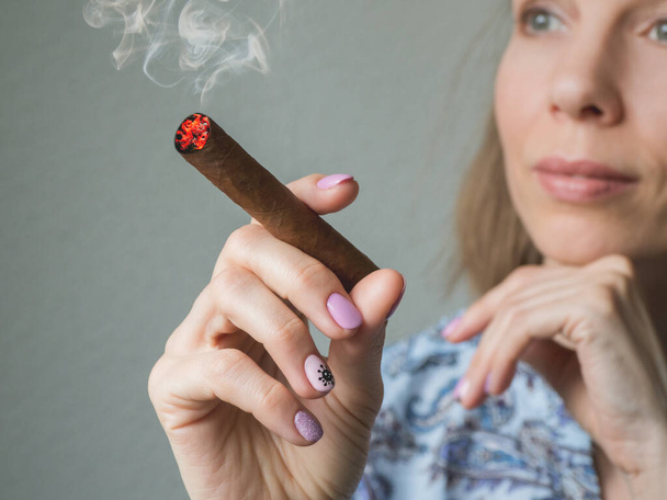 A lady dreams with a cigar. Cuban cigars concept - 写真・画像