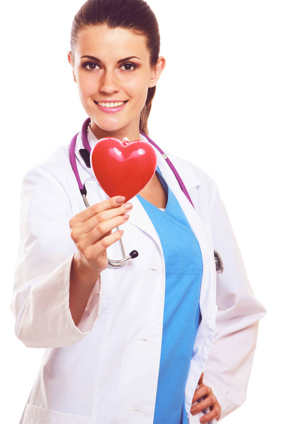 Young woman doctor holding a red heart, isolated on white background. Woman doctor - 写真・画像