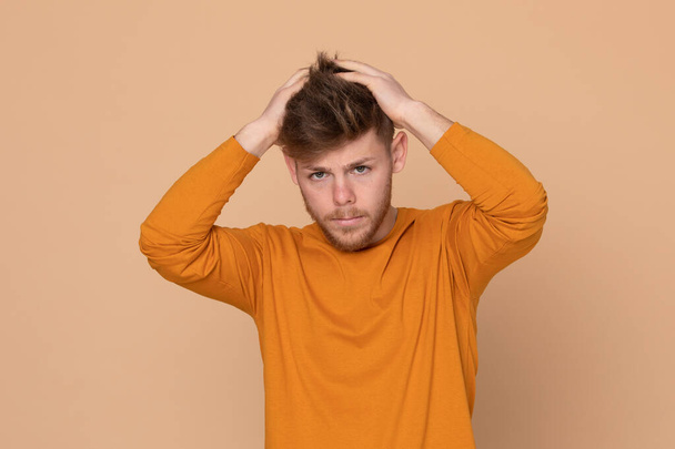 Attractive young guy on a yellow background - Foto, afbeelding