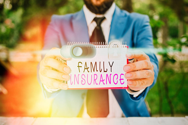 Writing note showing Family Insurance. Business photo showcasing paying a partial or full health care for relatives. - Photo, Image