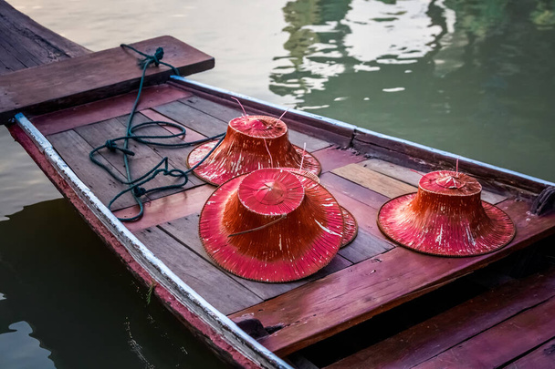Red hats in a boat at famous Pattaya Floating Market which has traditional rowing boats. Villagers sell traditional foods and souvenirs. - Photo, Image