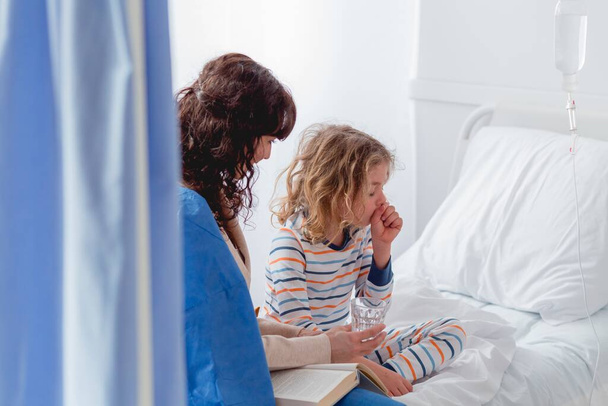 Little sick girl in a hospital having a cough - Foto, Bild