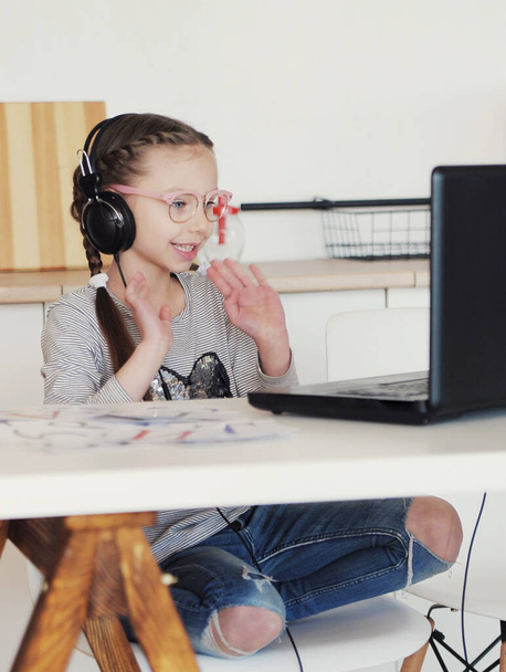 Girl is studying at home on quarantine. Online and remote education concept. - 写真・画像