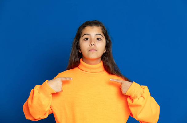 Adorable preteen girl with yellow jersey on a blue background - Φωτογραφία, εικόνα
