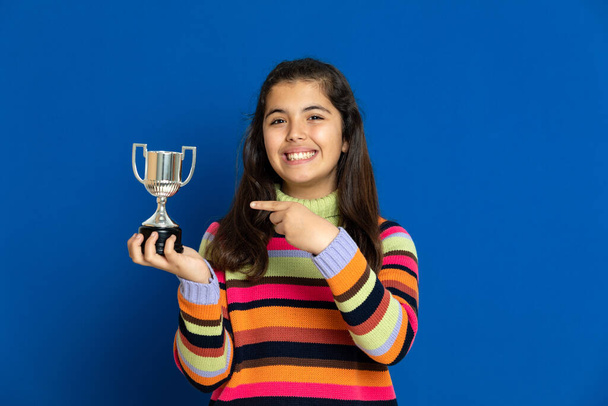 Adorable preteen girl with striped jersey on a blue background - Photo, Image