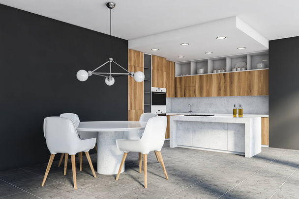 Corner of modern kitchen with grey walls, wooden countertops and cupboards, island with built in cooker and round dining table with white chairs. 3d rendering - Fotografie, Obrázek