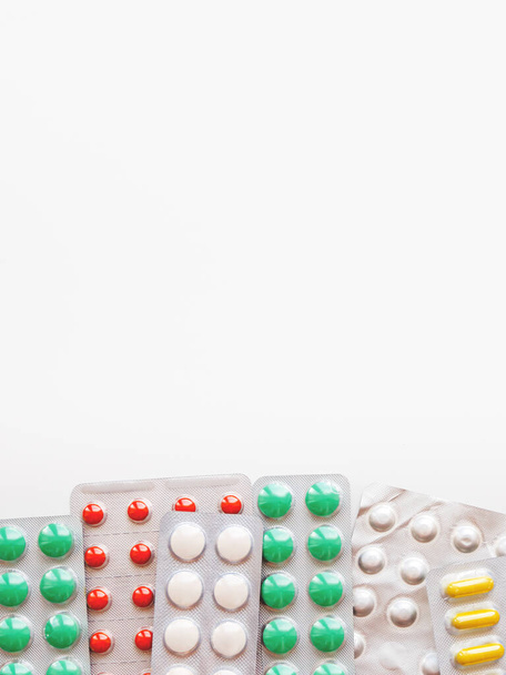 Top view on pills in plastic packs. Concept of different medicines on white background with copy space. - Foto, immagini