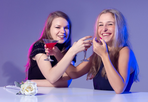 Female friends enjoying cocktails in a nightclub - Photo, Image