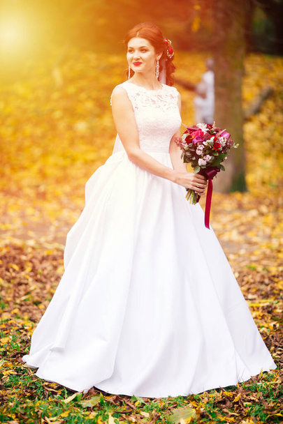 Beautiful bride outdoors in a forest. Wedding day. - Foto, Imagen