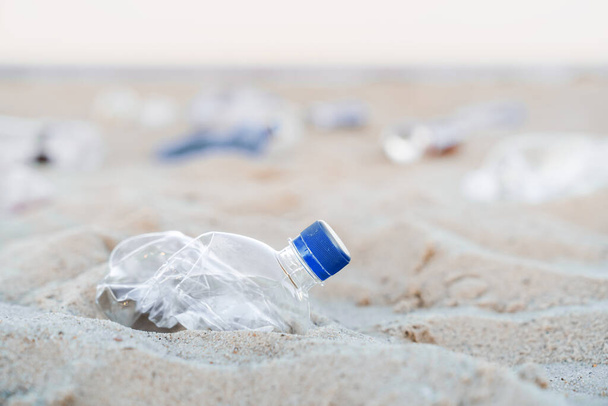 Close up shot of bottle plastic garbage on the beach - Valokuva, kuva