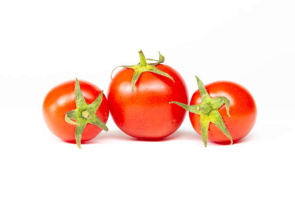 Red cherry tomatoes isolated on white background - 写真・画像