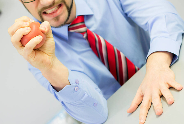 Angry boss squeezing stress ball in the office. - Photo, Image