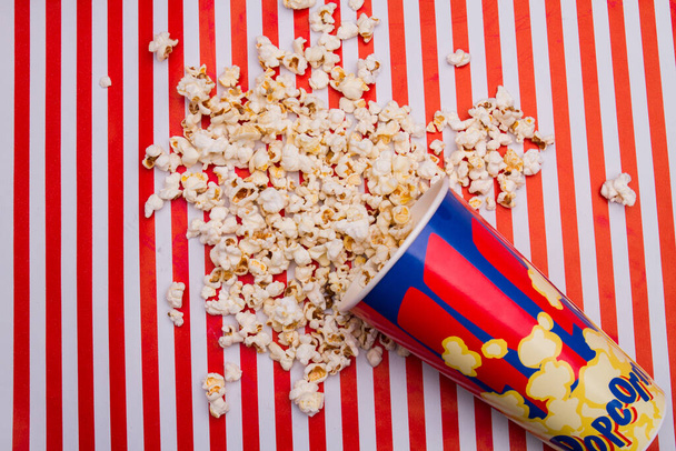 Popcorn was scattered from bucket. - Фото, изображение