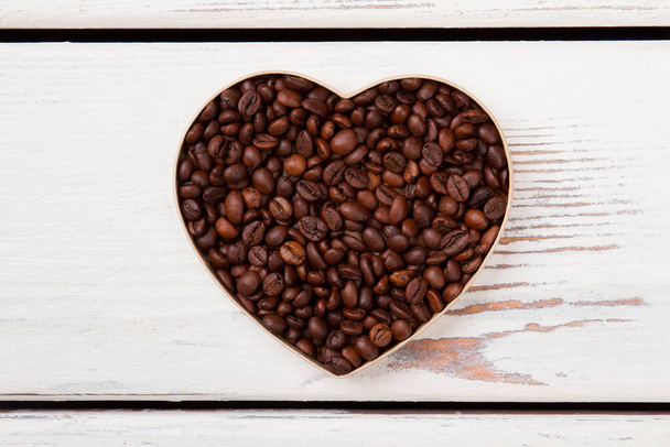 Flatlay heart shaped roasted coffee beans. - Фото, зображення