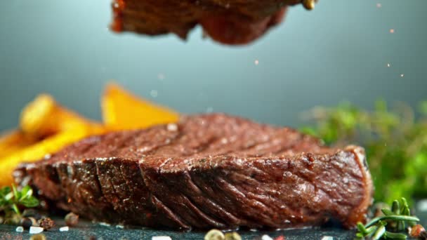 Close-up of falling tasty beef steak, slow motion. - Video